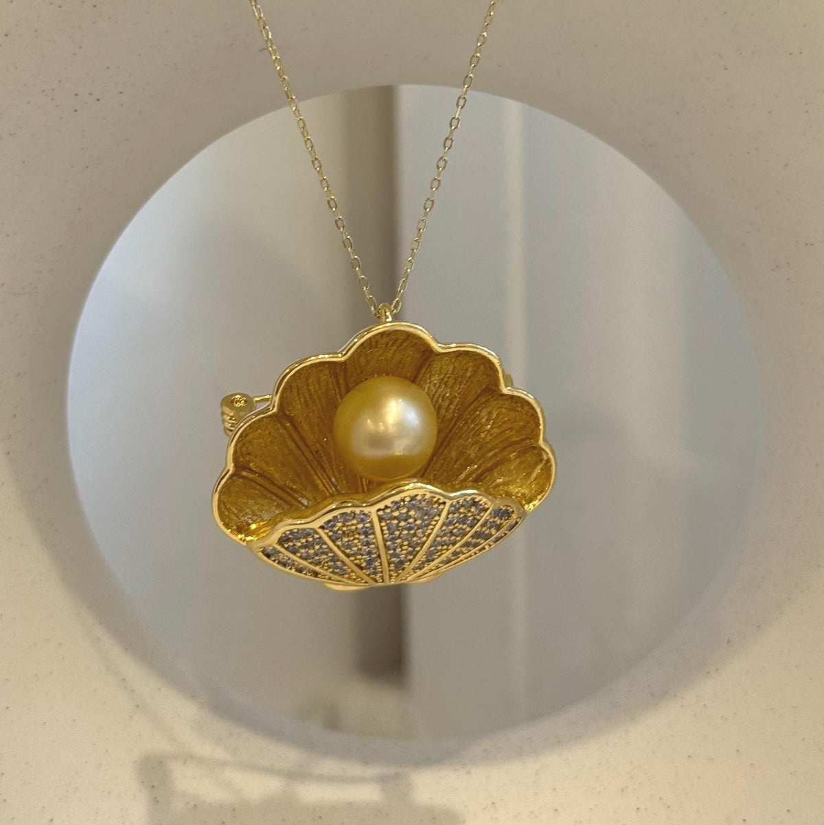 Elegant shell-inspired brooch crafted with a genuine South Sea golden pearl.