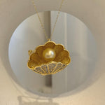Elegant shell-inspired brooch crafted with a genuine South Sea golden pearl.