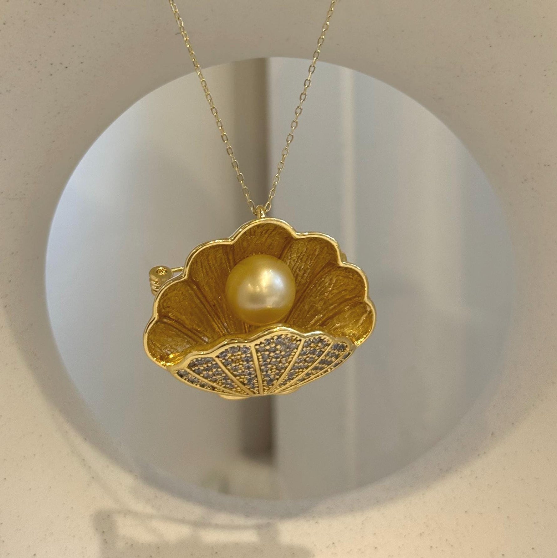 Elegant shell-inspired brooch crafted with a genuine South Sea golden pearl.