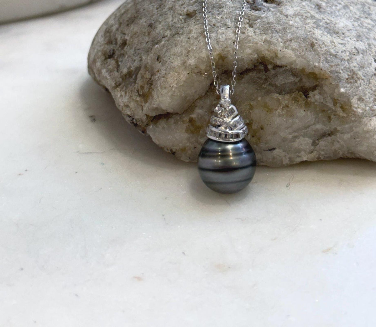 Large black Tahitian pearl pendant crafted with sterling silver for timeless elegance.