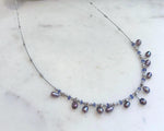 Genuine freshwater Keshi pearl necklace featuring natural Tanzanite accents and mirror luster.
