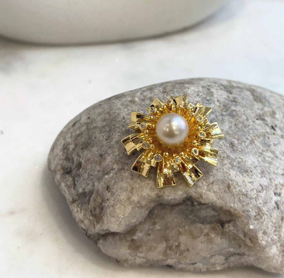 Nature-inspired flower brooch with brilliant mirror-luster ocean pearl.