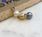 Premium three-pearl statement necklace with golden, black, and white ocean pearls.