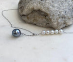 Genuine Tahitian pearl necklace with white freshwater pearl accents and sterling silver.