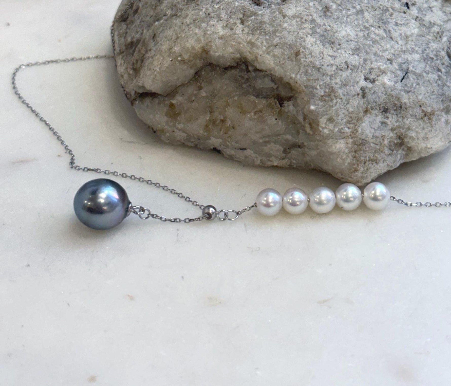 Genuine Tahitian pearl necklace with white freshwater pearl accents and sterling silver.