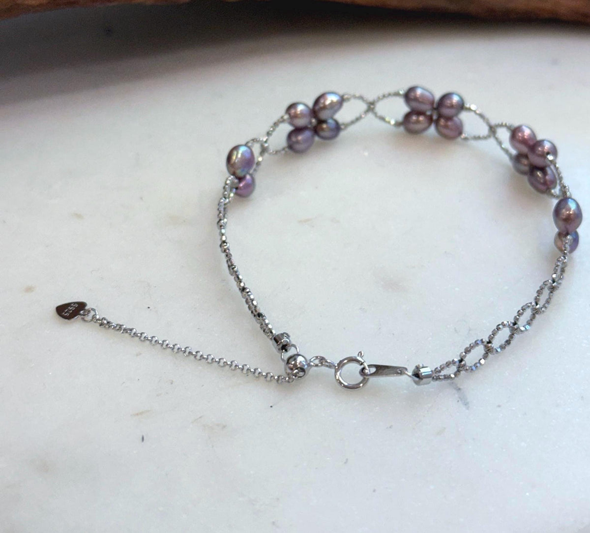 Elegant adjustable sterling silver bracelet with genuine freshwater Keshi pearls and brilliant shine.