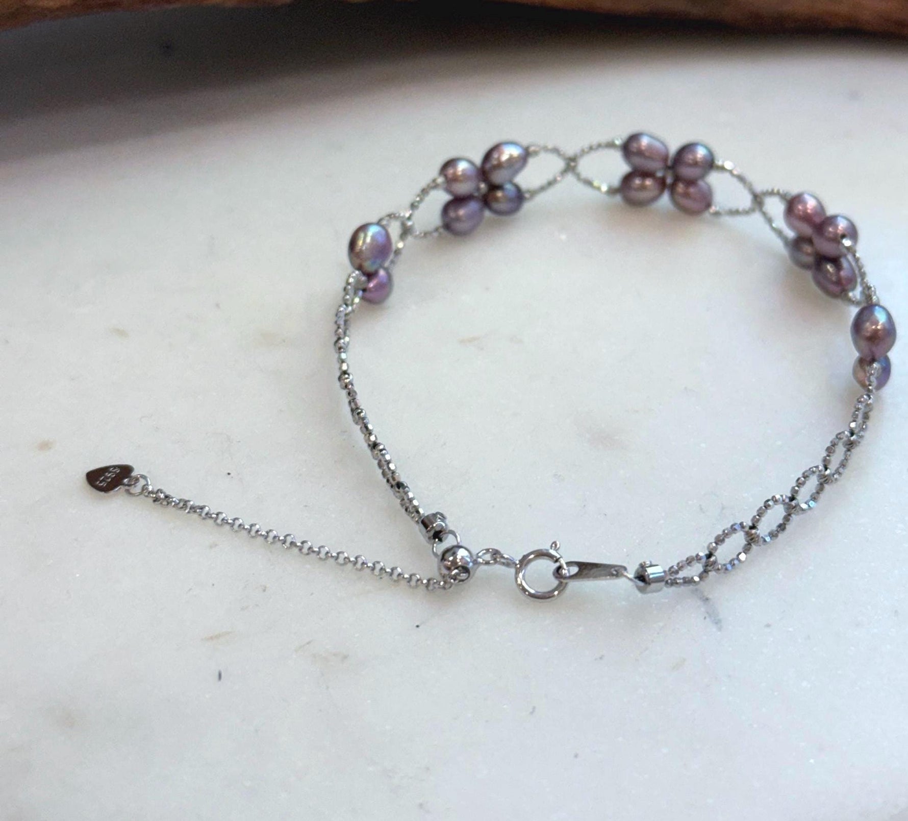 Elegant adjustable sterling silver bracelet with genuine freshwater Keshi pearls and brilliant shine.