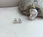 Elegant freshwater baroque pearl jewelry set featuring a statement pendant necklace and classic pearl stud earrings.