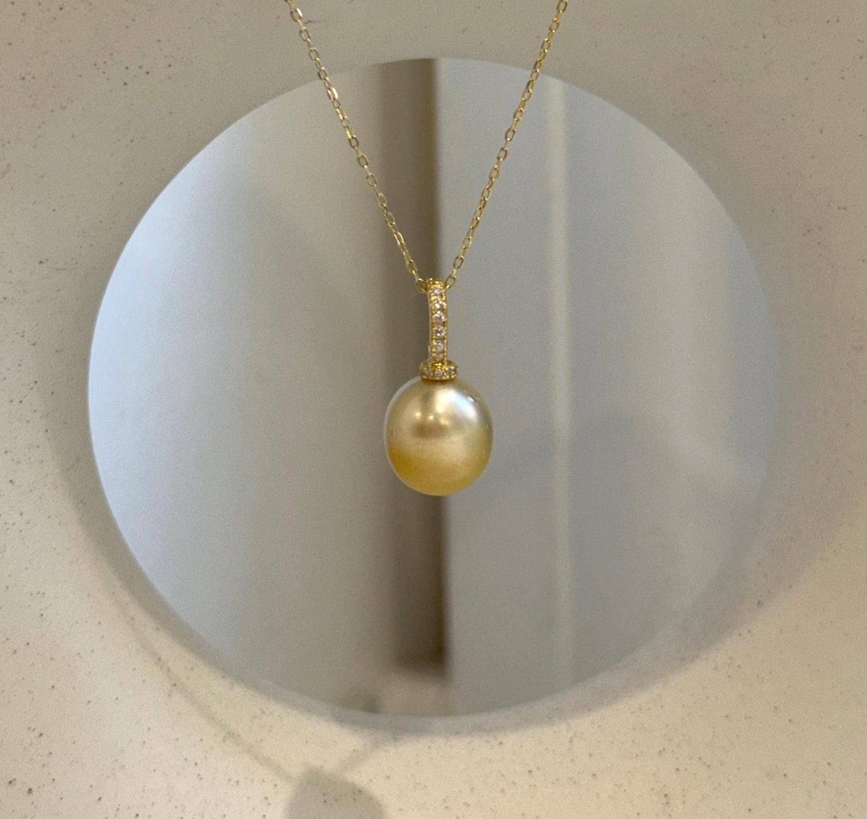 Close-up of an 11.2mm golden pearl showing rich natural color and reflective surface.