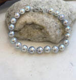 Close-up of highly reflective Japanese Akoya pearls in graduated sizes.