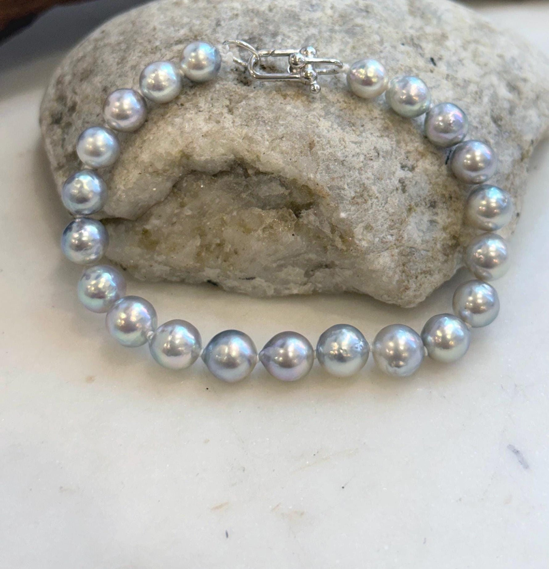 Close-up of highly reflective Japanese Akoya pearls in graduated sizes.