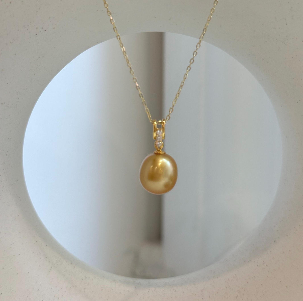 Genuine ocean pearl pendant handcrafted with a natural deep gold South Sea pearl and gold-plated silver.