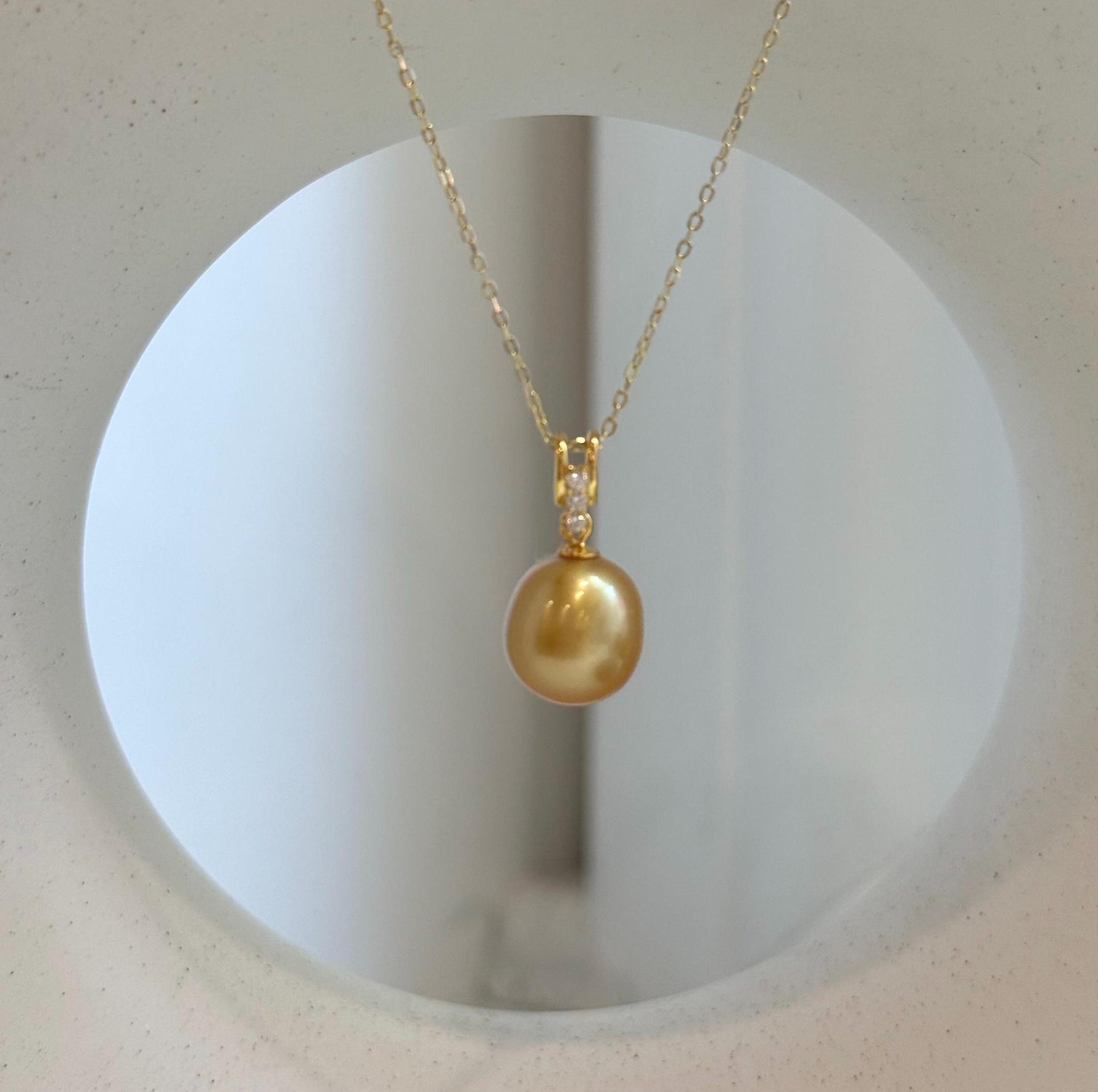 Genuine ocean pearl pendant handcrafted with a natural deep gold South Sea pearl and gold-plated silver.