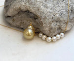 Genuine South Sea golden pearls paired with white freshwater pearls on an elegant Y necklace.