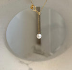 Minimalist pearl lariat necklace featuring South Sea golden and freshwater white pearls.