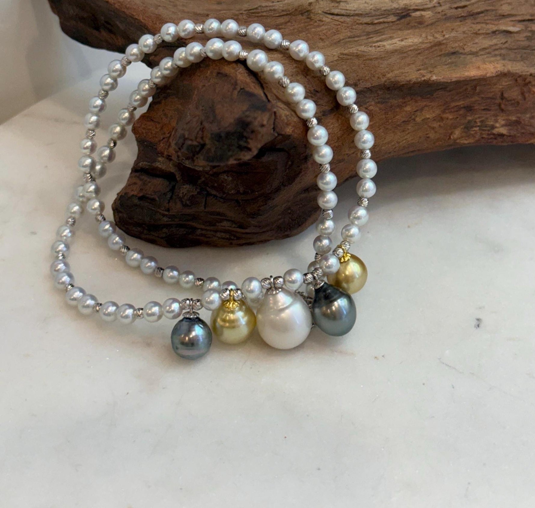 White pearl strand necklace with mixed ocean pearl centerpiece