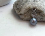 Genuine Tahitian saltwater pearl necklace featuring a round platinum gray pearl with high luster.