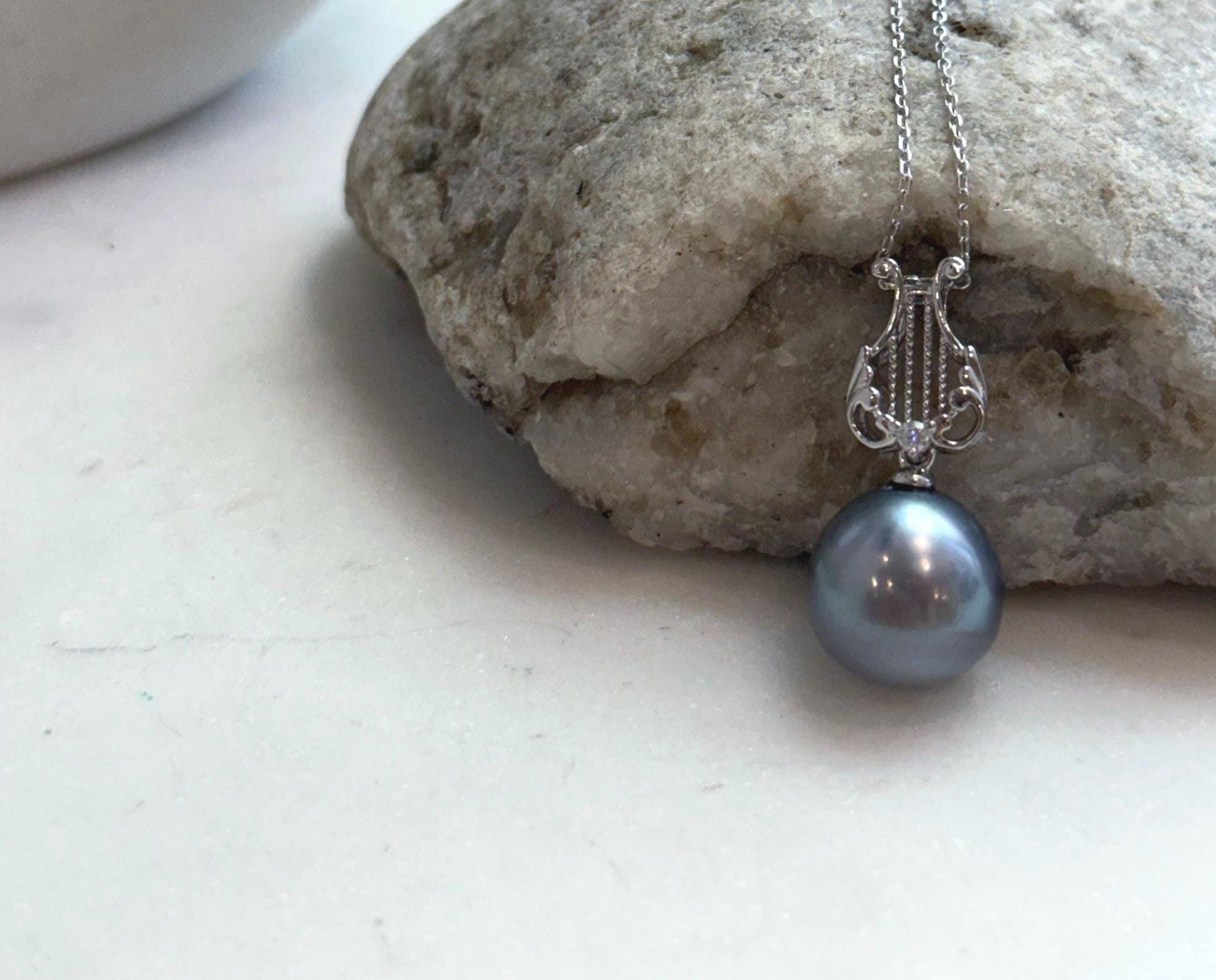 Genuine Tahitian saltwater pearl necklace featuring a round platinum gray pearl with high luster.