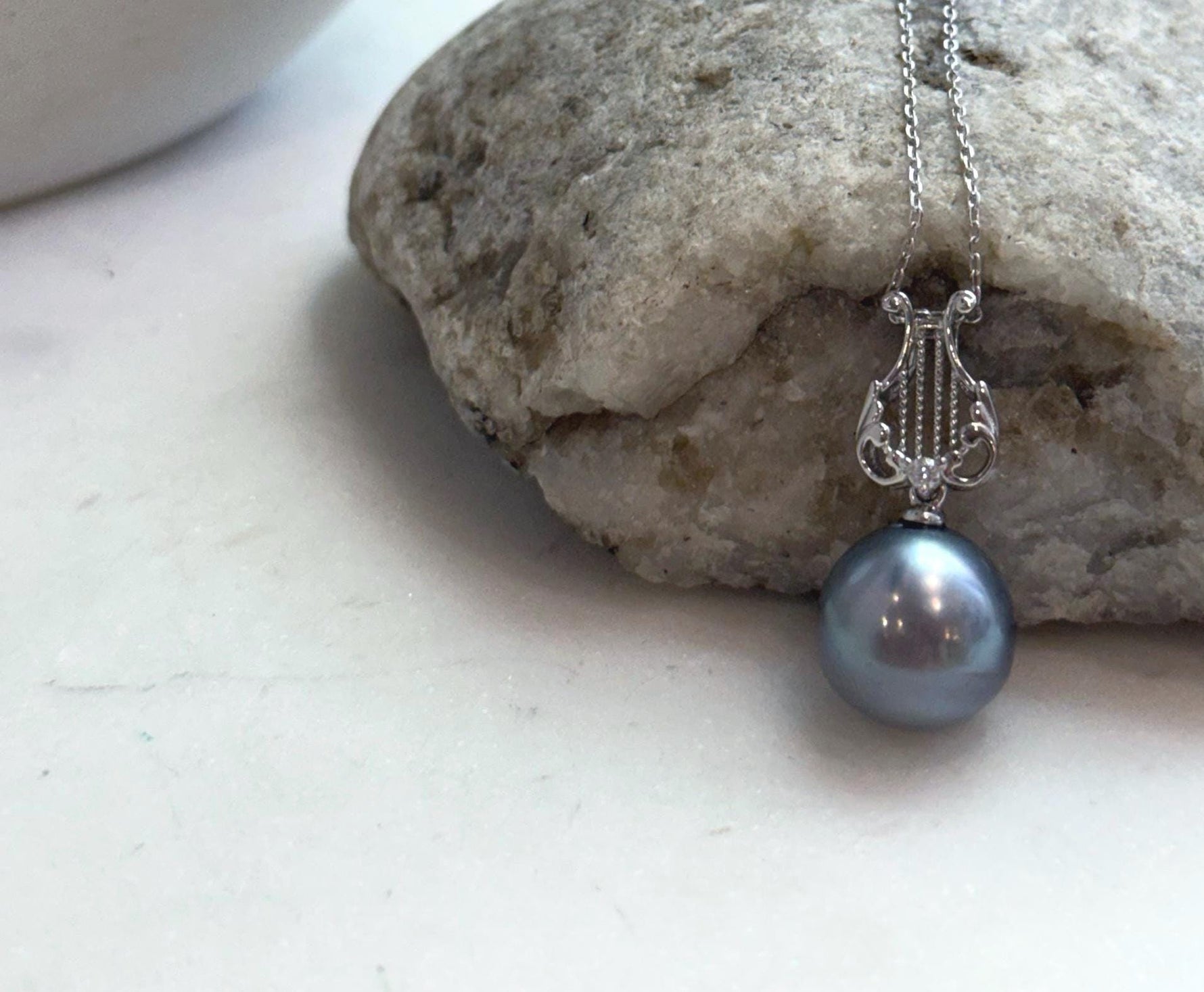 Natural 12.6mm Tahitian pearl pendant with elegant silver lyre bail and mirror finish.