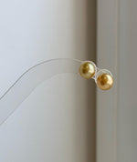 Minimalist South Sea pearl earrings featuring rich deep gold color
