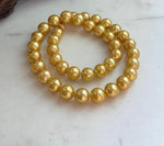 Close-up of lustrous 10.1–11mm Edison deep tea golden pearls