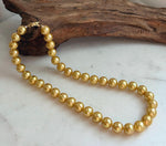 Deep tea golden Edison pearl strand featuring 39 round pearls