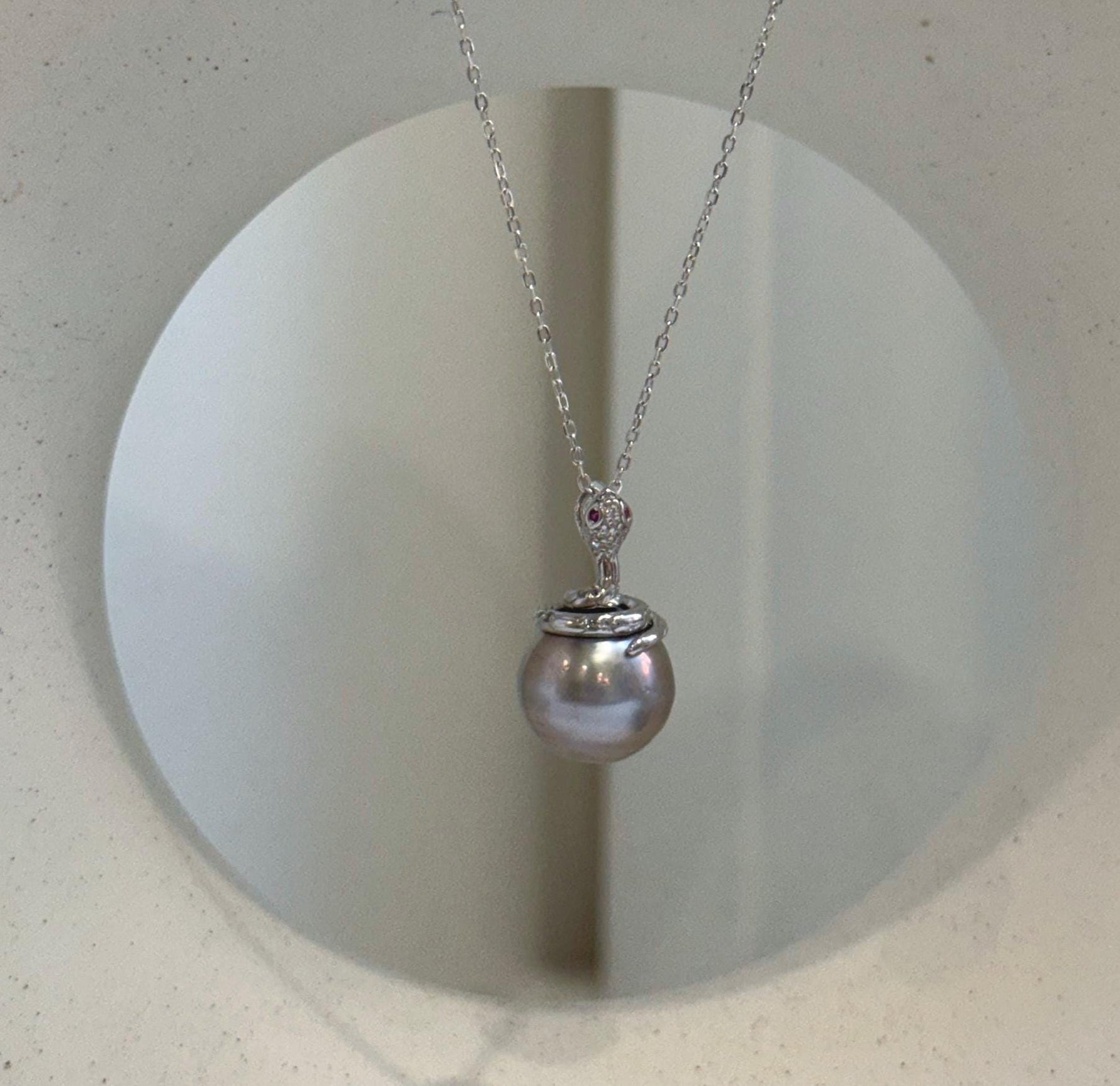 Elly’s 11.8mm Tahitian platinum pearl snake pendant with extreme mirror luster and S925 sterling silver setting.