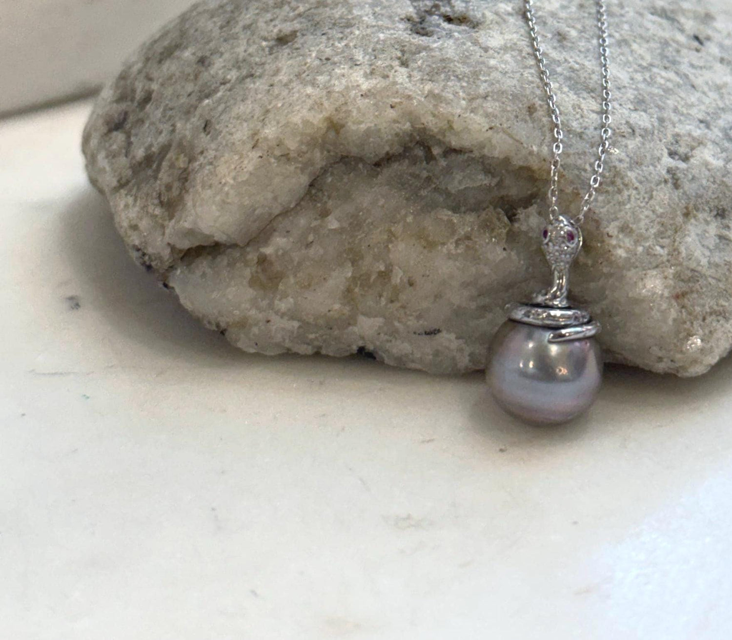 Genuine 11.8mm Tahitian saltwater pearl pendant featuring a unique sterling silver snake design.
