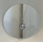 Luxury Tahitian platinum pearl necklace pendant featuring extreme luster and a modern snake design.