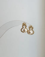 Genuine freshwater pearl gourd earrings displayed in soft natural lighting.