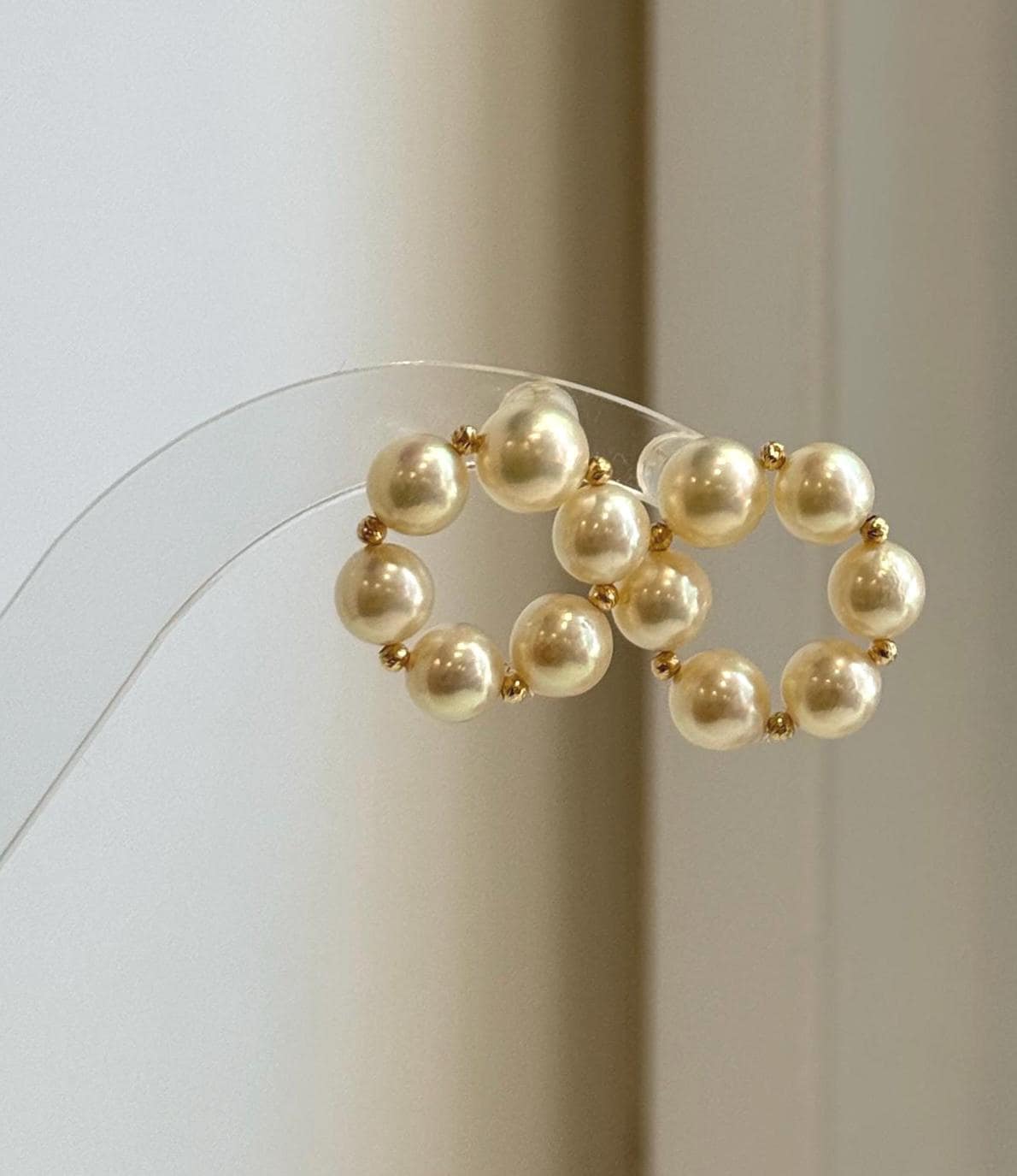 Elegant minimalist Akoya pearl stud earrings with donut-shaped golden pearls for everyday luxury wear.