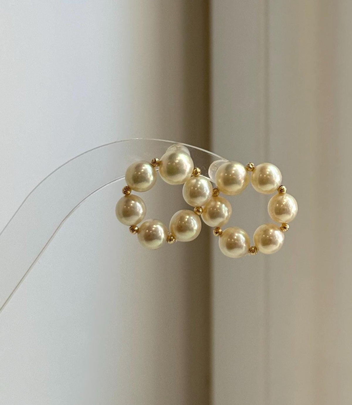 Genuine saltwater Akoya pearl stud earrings in warm golden tones, perfect for weddings and special occasions.