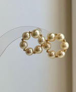 Luxury Japanese Akoya pearl earrings with smooth round donut pearls and polished 18K gold settings.