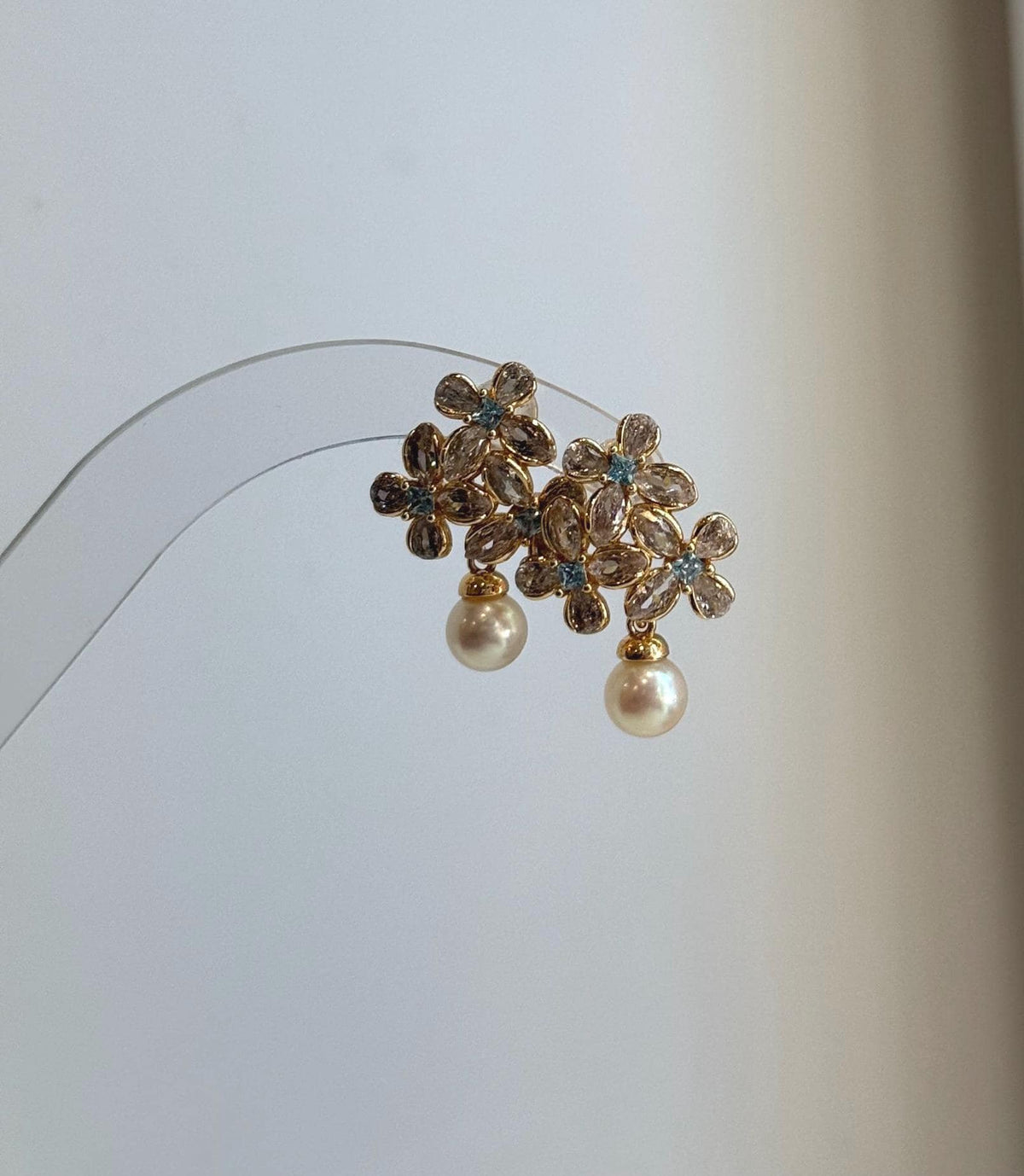Elegant floral pearl stud earrings crafted with genuine Japanese Akoya pearls.