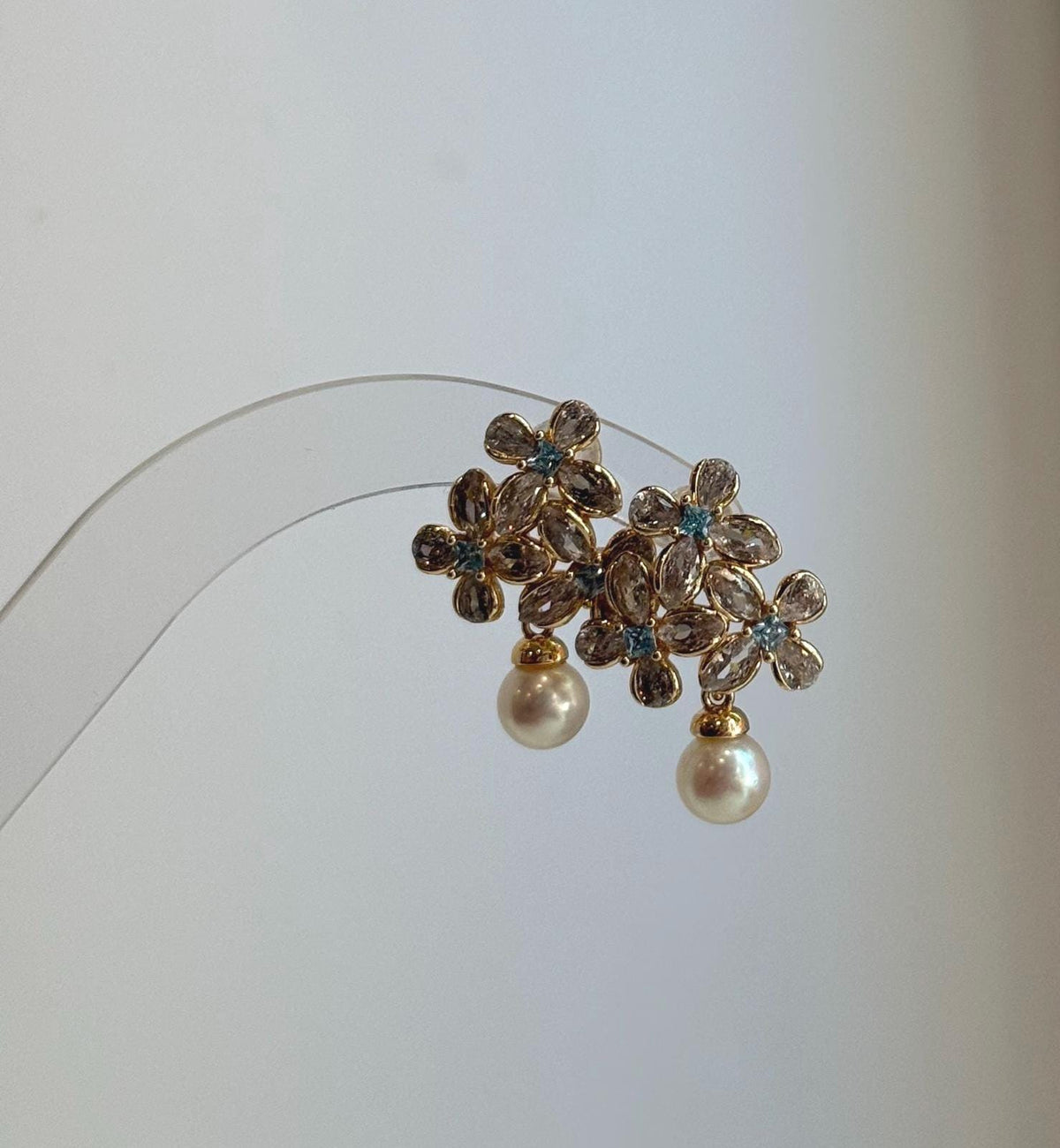 Elegant floral pearl stud earrings crafted with genuine Japanese Akoya pearls.