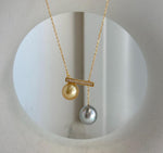 Luxury two-pearl pendant featuring rare natural ocean pearl colors.