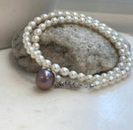 Mirror luster purple Edison pearl centerpiece with lustrous white pearls.