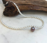 White freshwater pearl necklace with a unique purple lavender Edison pearl centerpiece.