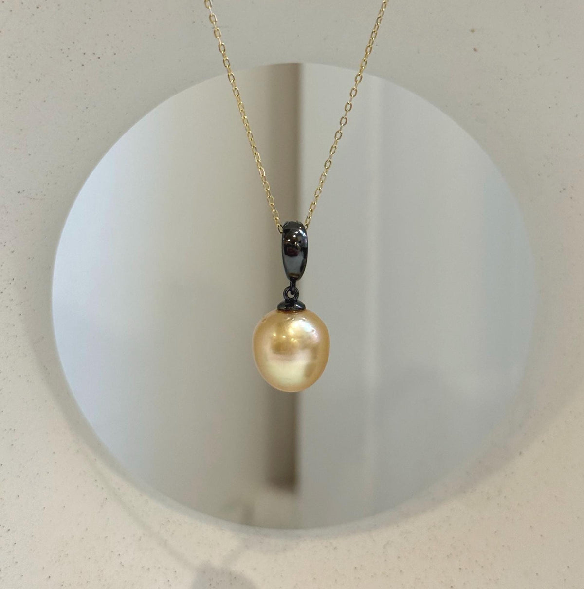 Close-up of 11.2mm deep tea golden South Sea pearl with beautiful mirror-like luster.