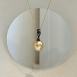 Close-up of 11.2mm deep tea golden South Sea pearl with beautiful mirror-like luster.