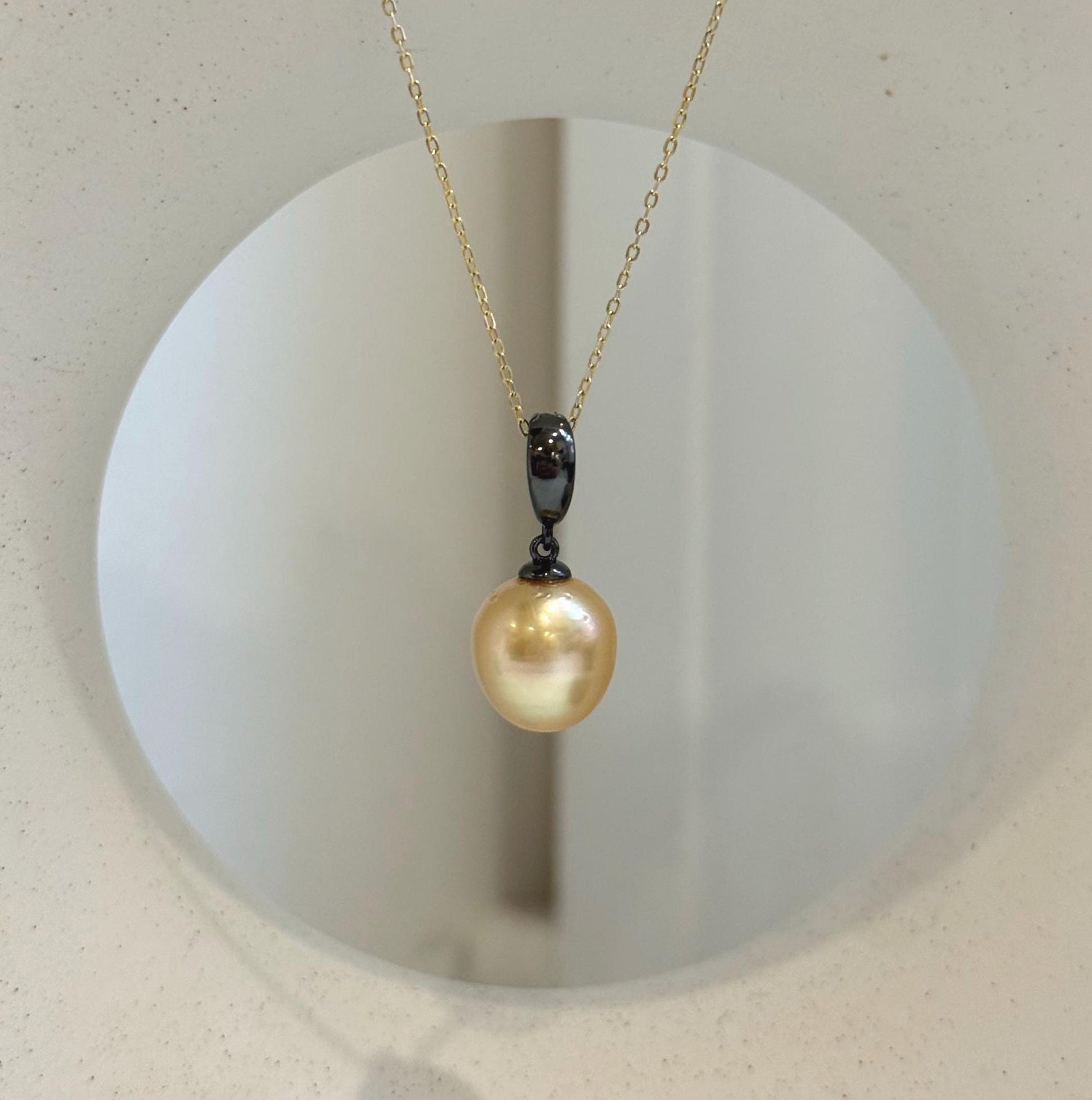 Close-up of 11.2mm deep tea golden South Sea pearl with beautiful mirror-like luster.