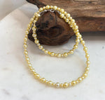 Genuine golden freshwater pearl strand necklace featuring naturally elegant warm tones.