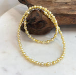 Genuine freshwater pearl necklace with warm golden color and high reflective luster.