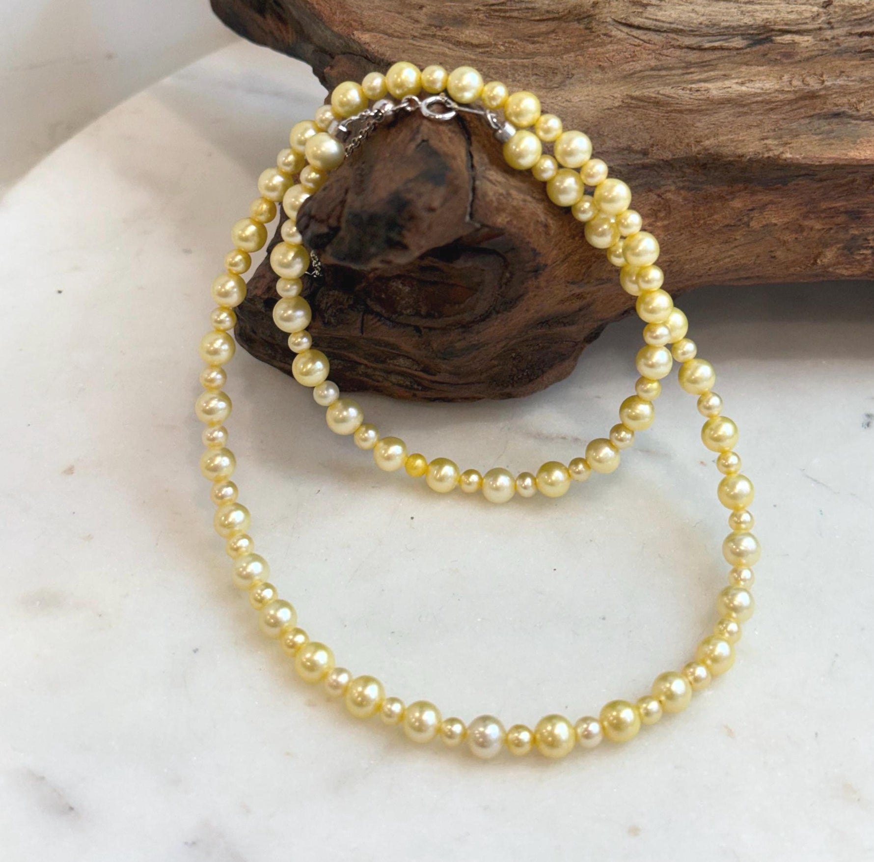 Genuine freshwater pearl necklace with warm golden color and high reflective luster.