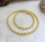 Classic 18.7-inch golden pearl strand necklace with S925 sterling silver hardware.