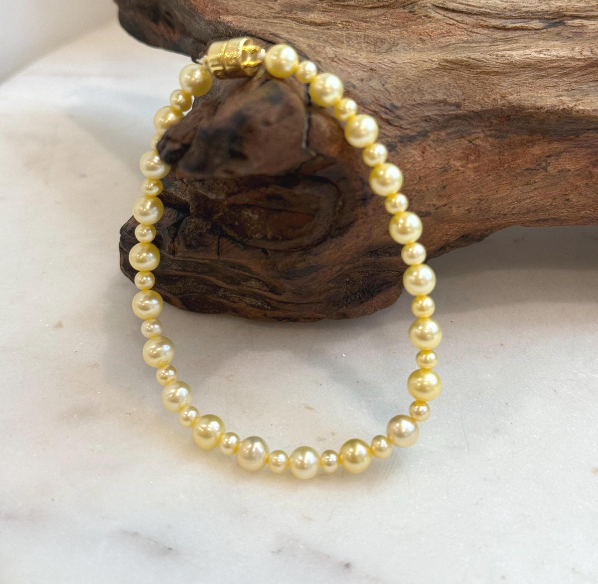 Golden freshwater pearl bracelet with 3.5–5.5mm genuine pearls and mirror luster.