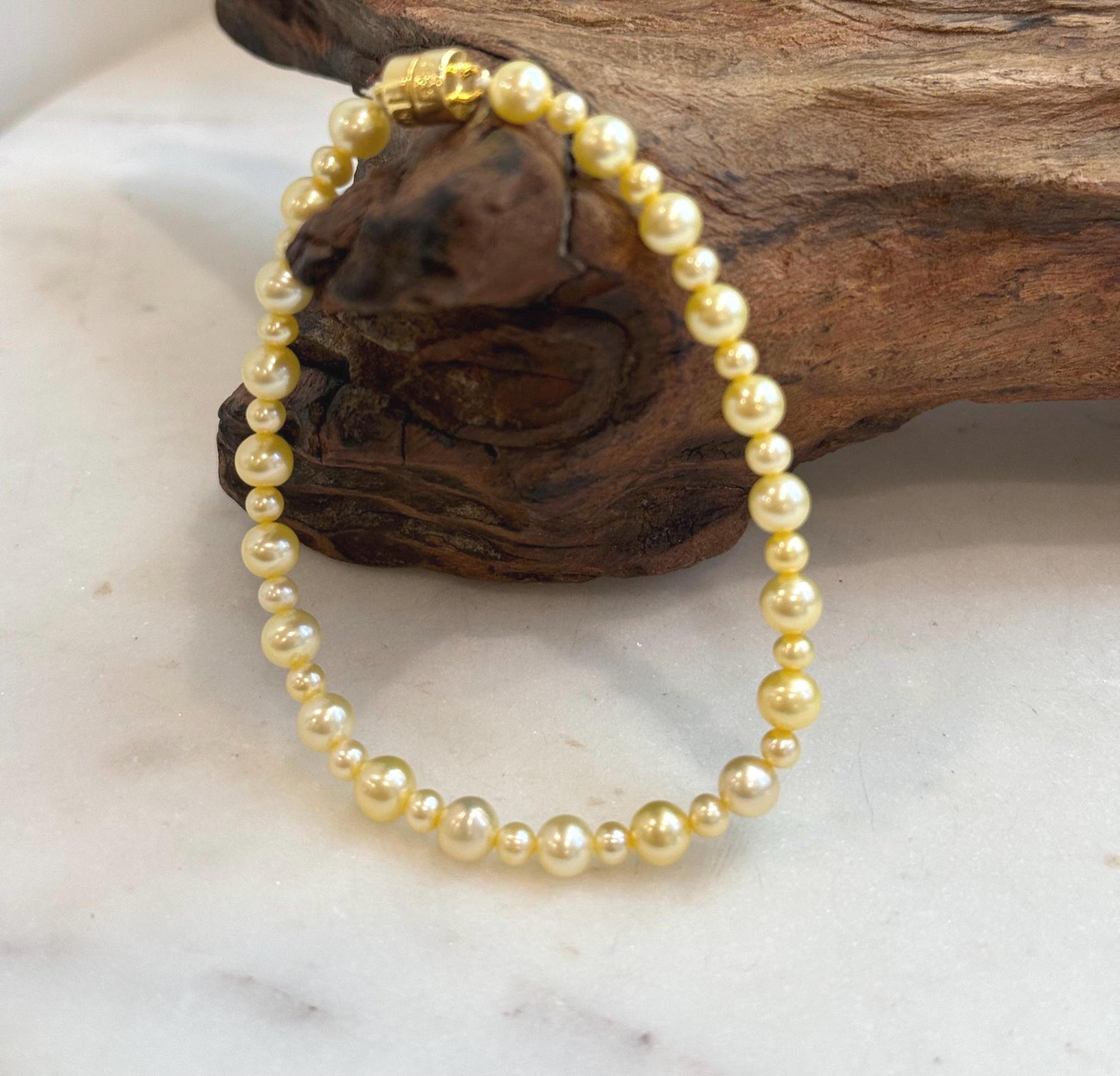 Close-up of lustrous golden freshwater pearls showing their smooth surface and shine.