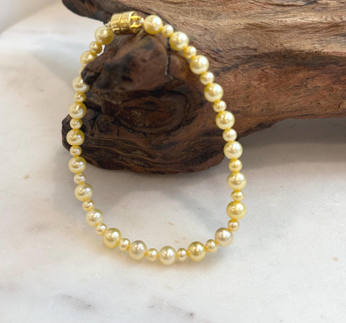 Genuine freshwater pearl jewelry with warm golden tones and mirror-like luster.
