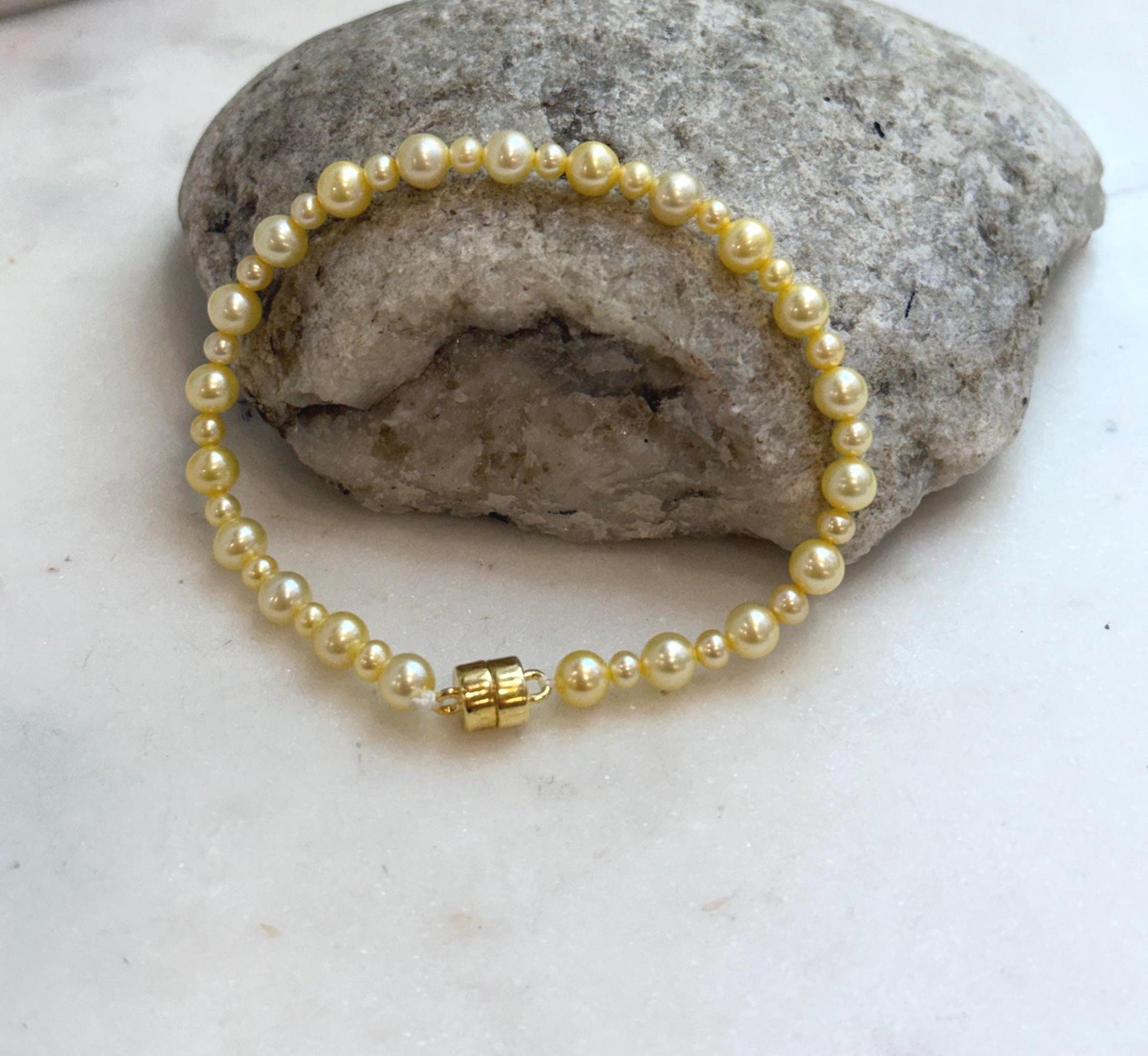 Natural freshwater pearl bracelet with radiant golden color and sterling silver closure.