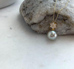Rare silver pistachio Tahitian pearl pendant displayed on a delicate necklace chain.